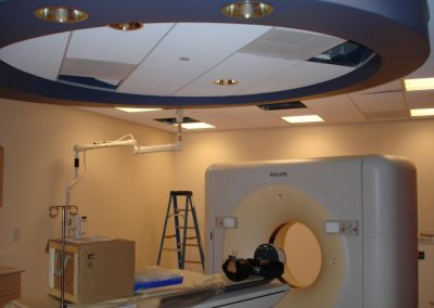 Final check of a few light fixtures in the drop ceiling using the six foot ladder sitting beside the newly installed MRI scanner