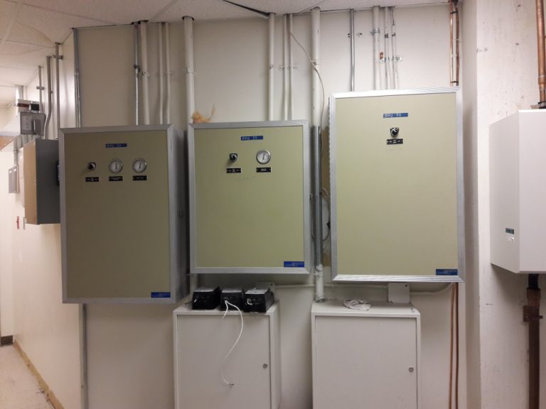 Conduit running down the back wall and into wall mounted switchgear and monitoring equipment