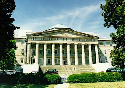 View from the street of the wide concrete steps and large majestic columns on the face of the historic first US Naval Hospital