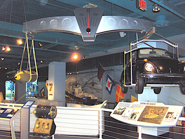 An exhibit in the Nauticus Naval Heritage Museum demonstrating its weight by showing a torpedo counter balanced by a Volkswagen Beetle on a large scale suspended from the ceiling