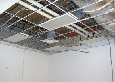Metal frame for the drop ceiling grid with nothing but a few light fixtures and a supply grille installed in it
