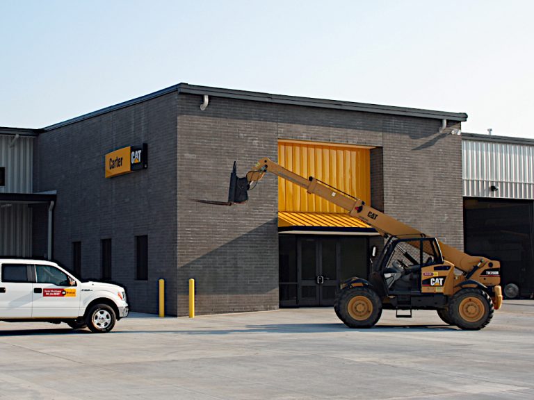 Caterpillar Telescopic Handler vehicle parked in the parking lot in front of the Carter Machinery shop