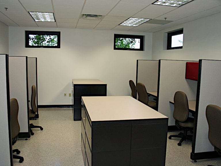 File cabinets and work cubicles with rolling chairs insidethe office space at Carter Machinery