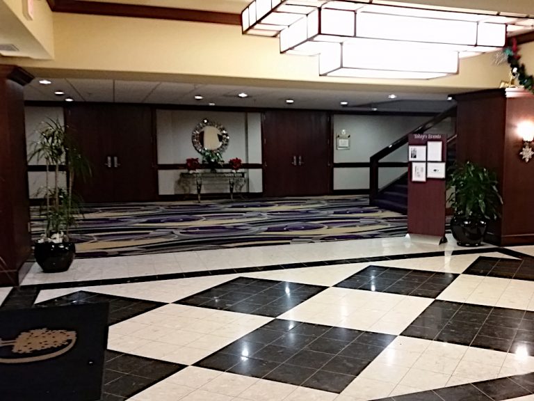 The Doubletree Hotels' stylized lobby complete with black and white checkered flooring and a large multilevel smoked glass and wood art deco light fixture