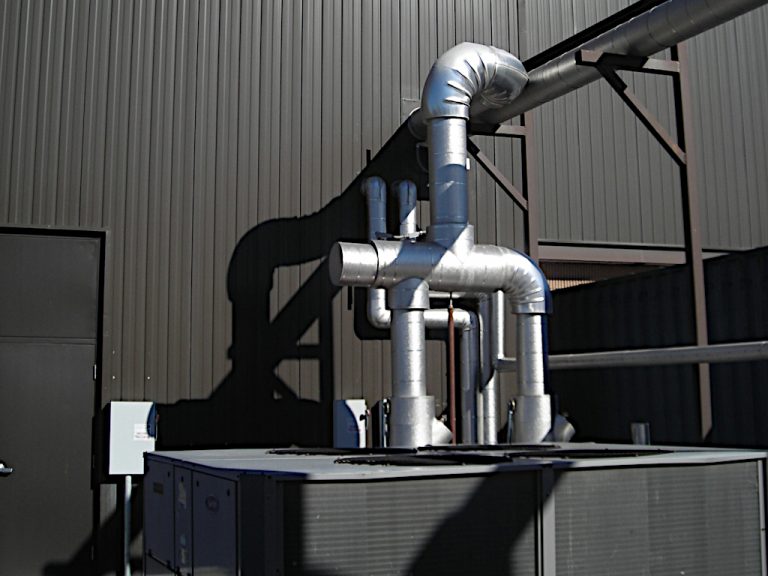 HVAC equipment and rounded metal ductwork shown outside of STIHL Company Virginia Beach's building