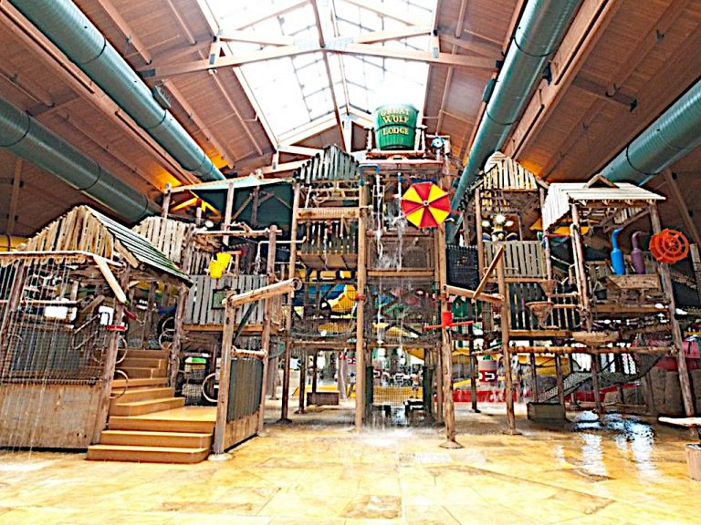 The giant wooden multi level fort type jungle gym with bridges and compartments adorned with lots of water activities