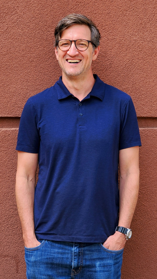 A Vansant & Gusler engineering professional wearing a casual shirt in front of the office building