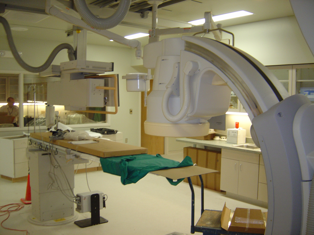 The new catscan machine being configured by a professional technician after being installed in this treatment room at Sentara Belleharbour healthcare facility.