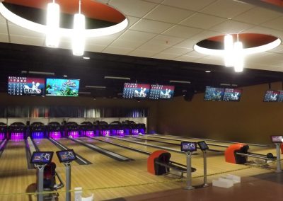 Modern accent lighting and neon pin deck lighting at the end of the shiny newly floored lanes at the Fort Lee Family Bowling Center