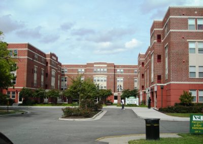 View of the landscaped parking lot and three wings of the new four story brick and concrete Norfolk State Spartan Suite dormitories